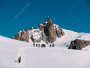 The Aiguille du Midi peak; in foreground a group of mountaineers