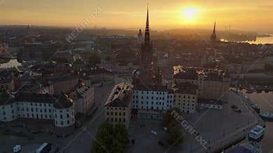 Sunrise over city landscape with buildings, river and tower in Stockholm during the morning. erial morning view of Gamla