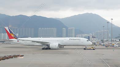 airside view in HKG Hongkong Airport while ground service staffs doing ground service operation push back Philippines airline