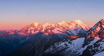 Majestic Snow Capped Mountain Range at Sunrise with Alpenglow Light