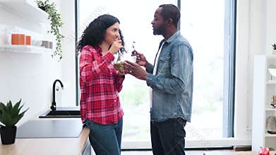 Couple Enjoying Salad in Modern Kitchen
