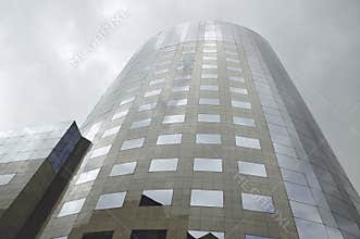 Modern corporate high rise building with reflective glass facade and contemporary urban architecture exterior