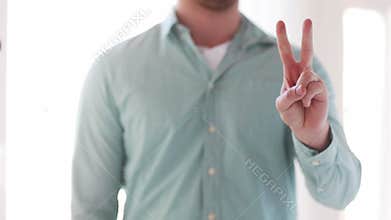 Close up of man showing fingers from one to three