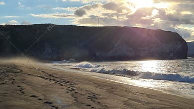 Afternoon sun over the sandy volcanic beach of Santa barbara, Ribeira Grande, Sao Miguel, Azores, Portugal