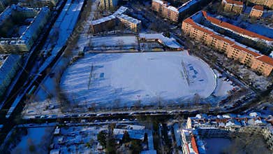 Berlin city showing snow covered soccer field. Magic aerial view drone