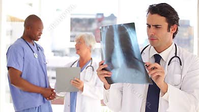 Smiling doctor looking at a chest xray