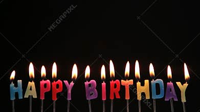 Happy birthday candles being blown out