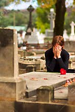 Woman Laying Flower on Grave