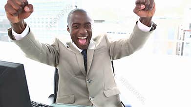 Black businessman shouting and raising arms