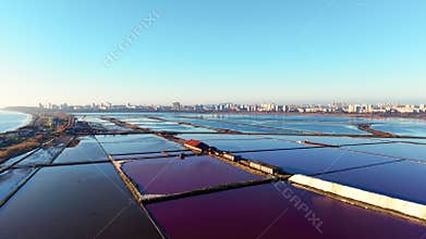 Aerial View of Salt Production Facility and Colorful Ponds Near Urban Area
