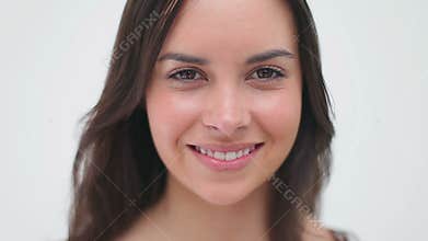 Happy brunette turns her head and looks at the camera