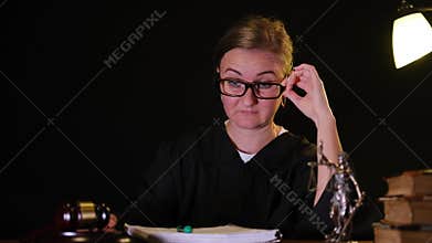 Tired female judge feeling stress in the courtroom