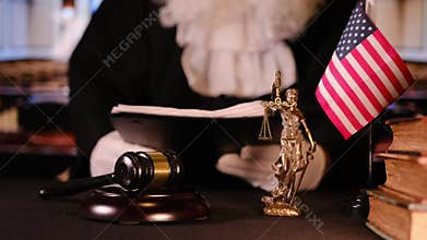 American judge reviewing legal documents in courtroom