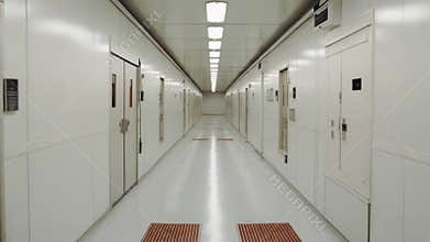 Long white sterile hallway with many doors