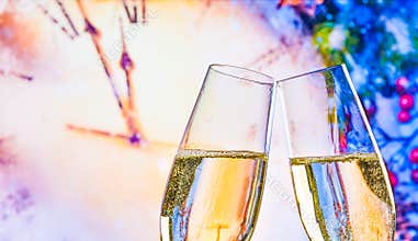New Year or Christmas at midnight with champagne flutes make cheers on clock background