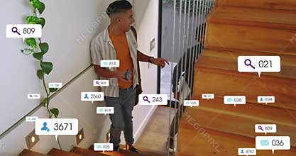 Gesturing man in striped overshirt, orange tee holding phone, wallet at home stairs with AR icons