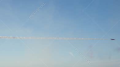 Aerobatic Jet Flies Across Blue Sky