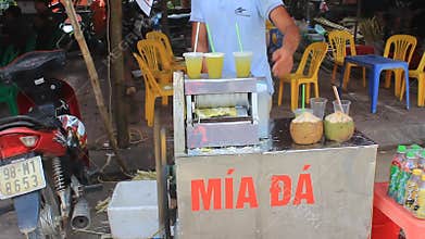 Man selling pressed sugarcane juice in the market