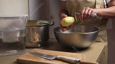 Person Preparing Fresh Vegetables in a Kitchen with Cutting Board and Utensils