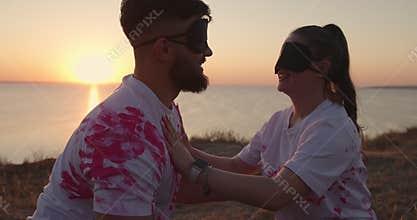 Gender party with blindfolded at sunset