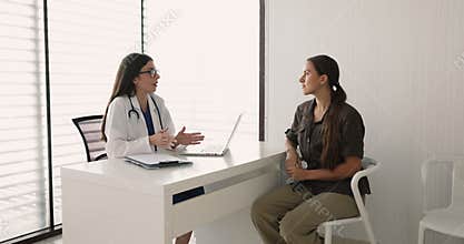 Female doctor giving consultation to patient in clinic