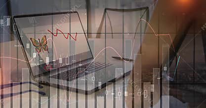 Laptop displaying butterfly icon and red trendline on conference table, with chart overlay