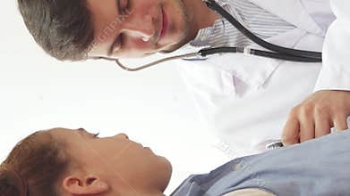 Caring doctor listens attentively to a young girl's lungs with a stethoscope