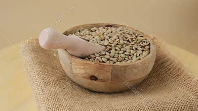 Green lentil in neutral beige background copy space.Whole spelt grain species. High protein fiber-rich vegan plant based