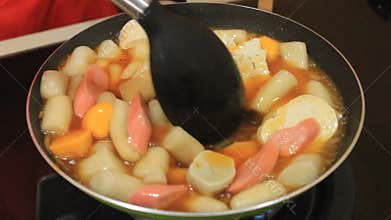 Someone is stir-frying spicy soup