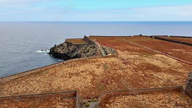 An Aerial View of Coastal Fortifications Set Against a Majestic Rocky Shoreline Landscape