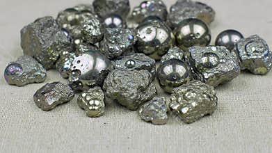 Detailed Close Up Production of Pyrite Ore Sorting Process Featuring Metallic Luster Crystals on a Neutral Background Perfect for