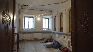 Room with arched windows shows renovation progress