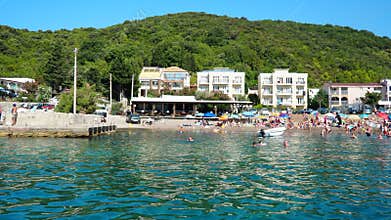Canj, Montenegro 08.10.2025: Visitors relax under the sun beach, enjoying warm weather and clear waters of Adriatic Sea. Families