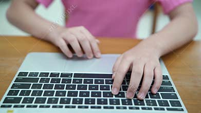 Hands typing on a laptop keyboard, close-up.