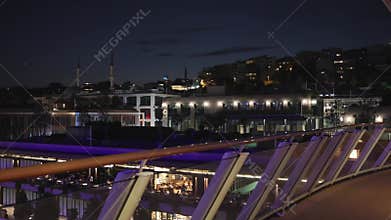View of Istanbul in evening. View of passenger port, pedestrian embankment, cafes and restaurants, Turkey. People