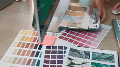 Color swatches and design tools arranged on a creative workspace showcasing various hues and shades for an artistic