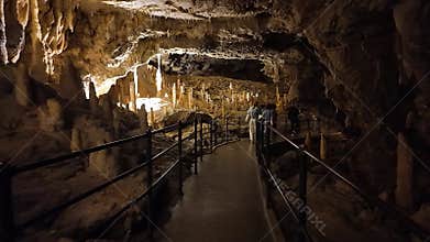 Tourists circulating through the passages of the impressive caves of Postojna, Slovenia.