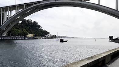 Traditional boat sailing on the Douro River under the Arrabida