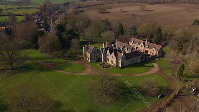 Aerial view of old manor house, stately home with Victorian era architecture and large green landscape