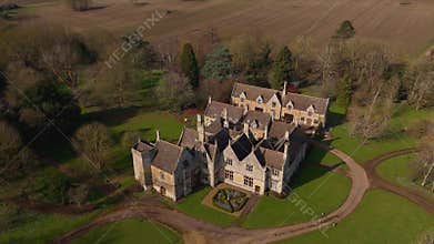 Aerial view of old manor house, stately home with Victorian era architecture and large green landscape