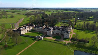 Aerial view of old manor house, stately home with Victorian era architecture and large green landscape