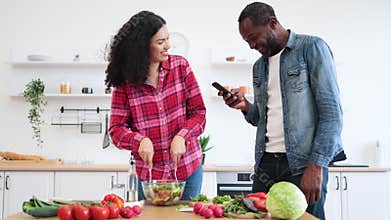 Couple Cooking Salad in Kitchen