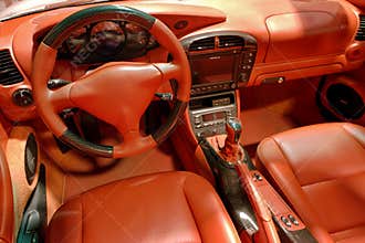 Luxury sports car interior showcases rich red leather and modern technology features in a stylish design