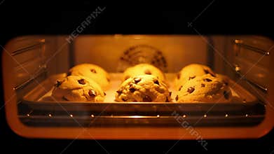 Time-lapse of Chocolate Chip Cookies Baking and Rising in a Hot Oven