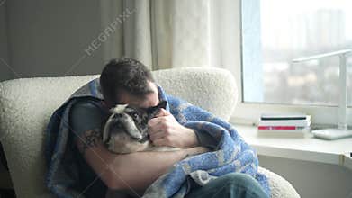 Man and his dog share a warm moment by the window on a cozy afternoon