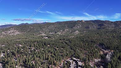 Aerial view of South Lake Tahoe pine forest and highway with lake background