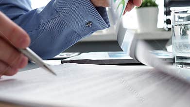 Hand of businessman in suit filling and