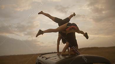 Two young women with perfect balance in handstand and headstand position