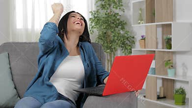 Excited woman finding amazing content on laptop
