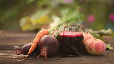 Beet-carrot-apple juice in glass on table